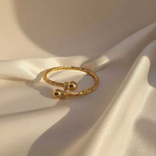 21k gold-plated twisted cable cuff bracelet with zirconia balls top angle view