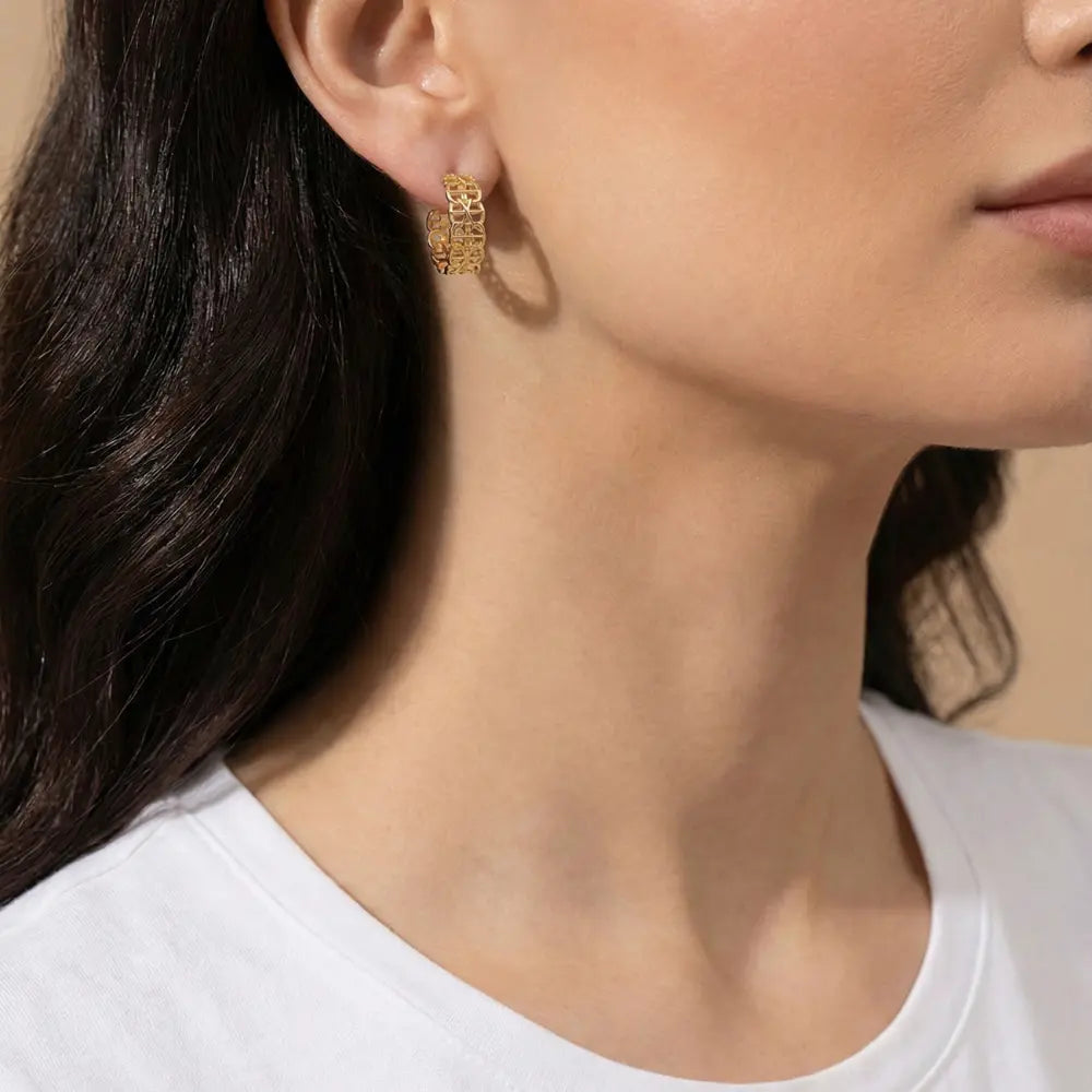 Close-up of a woman wearing Gold Plated Geometric Interlocking Link Earrings