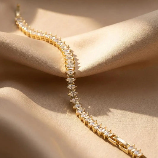 Gold Plated Marquise-Cut Tennis Bracelet on a beige fabric background