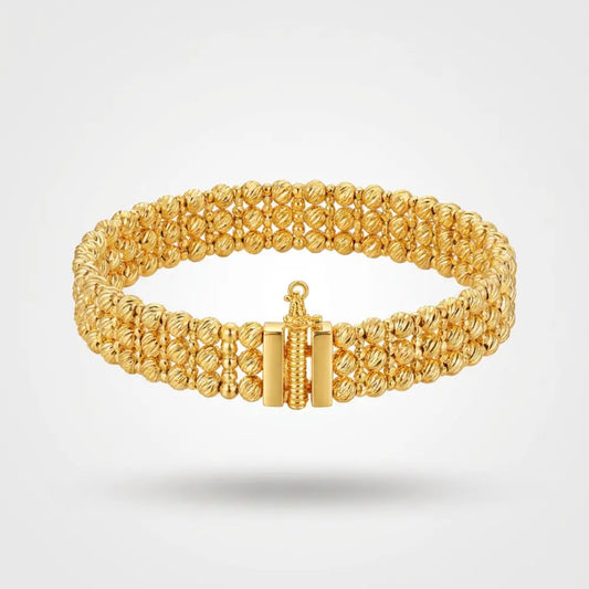 Gold Plated Ribbed Bead Bracelet on a light gray background