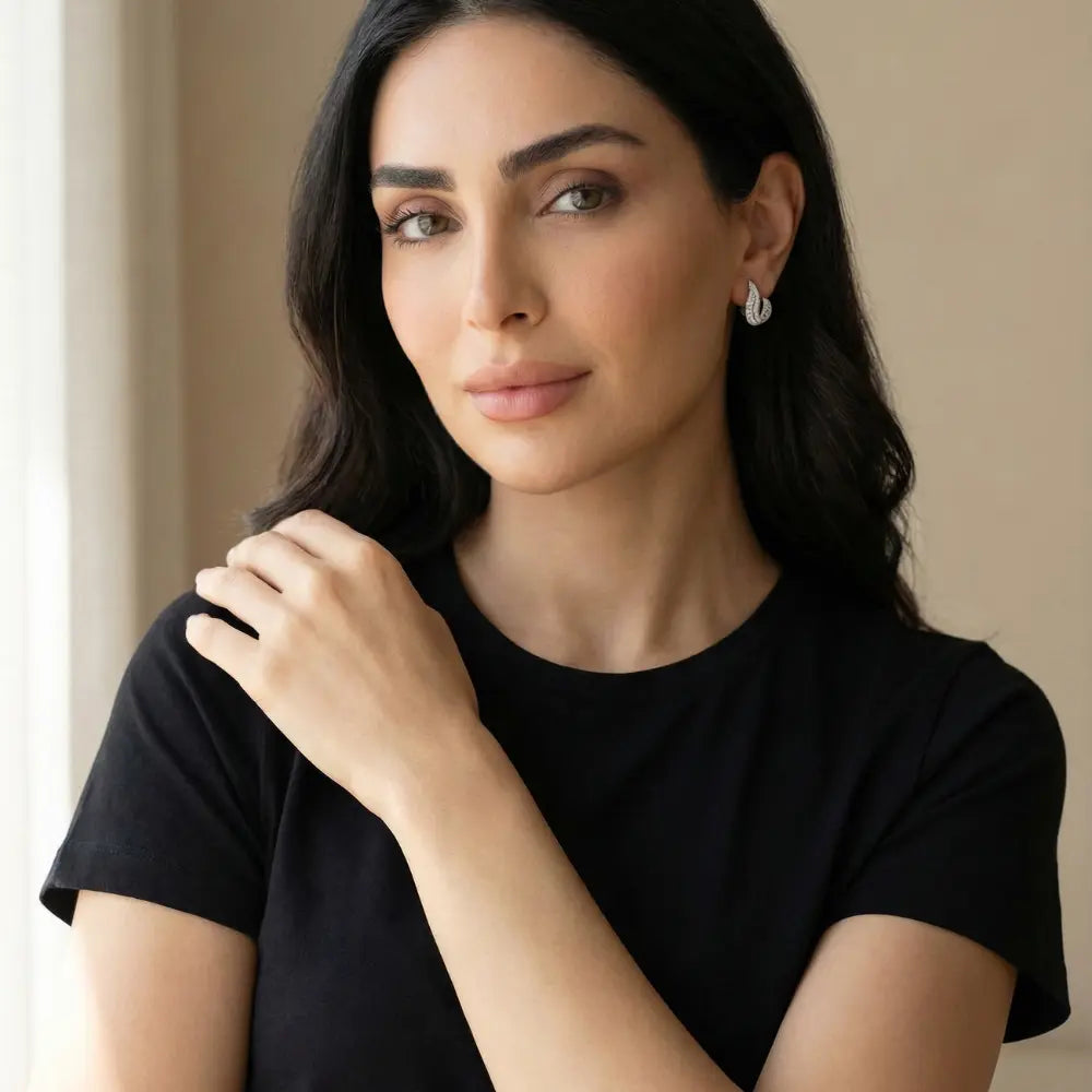 Woman wearing a black top and Silver-toned J-Hoop Earrings with Zirconia
