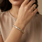 Close-up of a woman's hand wearing a Gold Plated Baguette X Bracelet & Ring Set