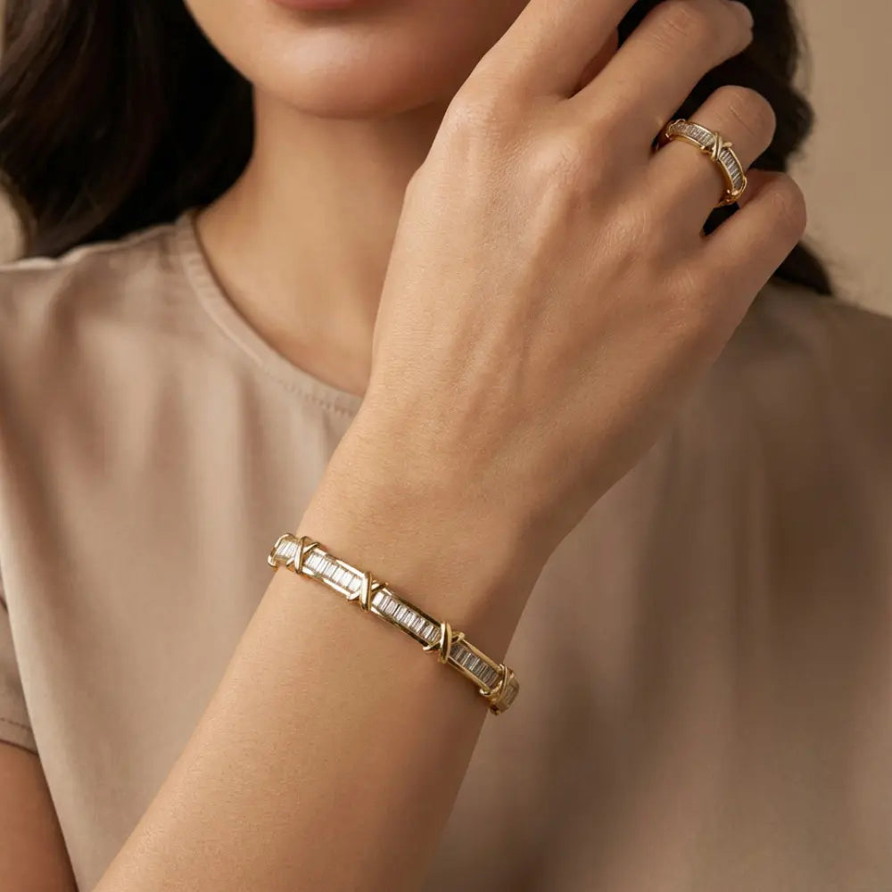 Close-up of a woman's hand wearing a Gold Plated Baguette X Bracelet & Ring Set