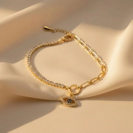Evil Eye Gold Crystal Bracelet on a beige surface