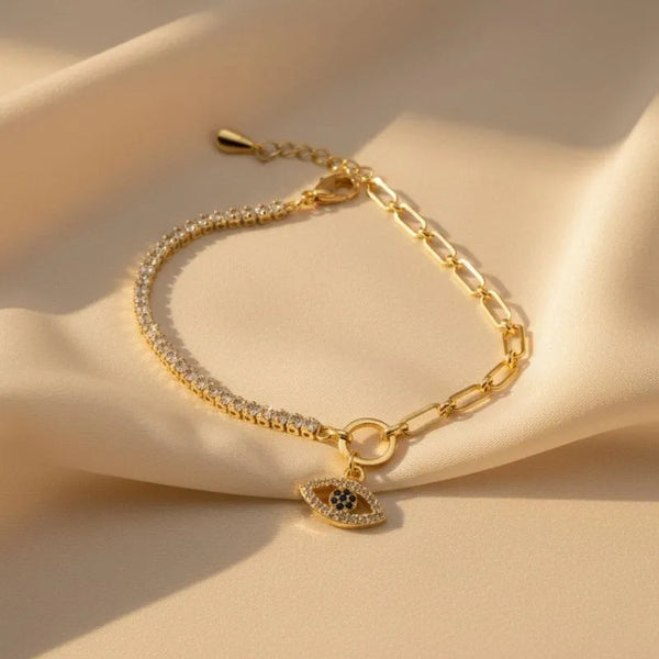 Evil Eye Gold Crystal Bracelet on a beige surface