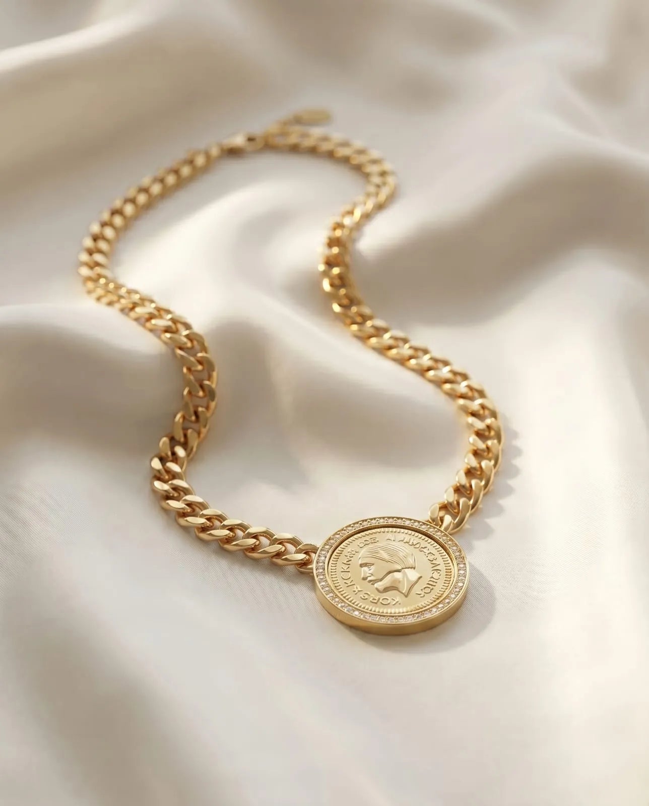 Gold plated statement necklace featuring a thick curb chain and a vintage engraved coin medallion framed with zircon crystals from Bellora Bloom.
