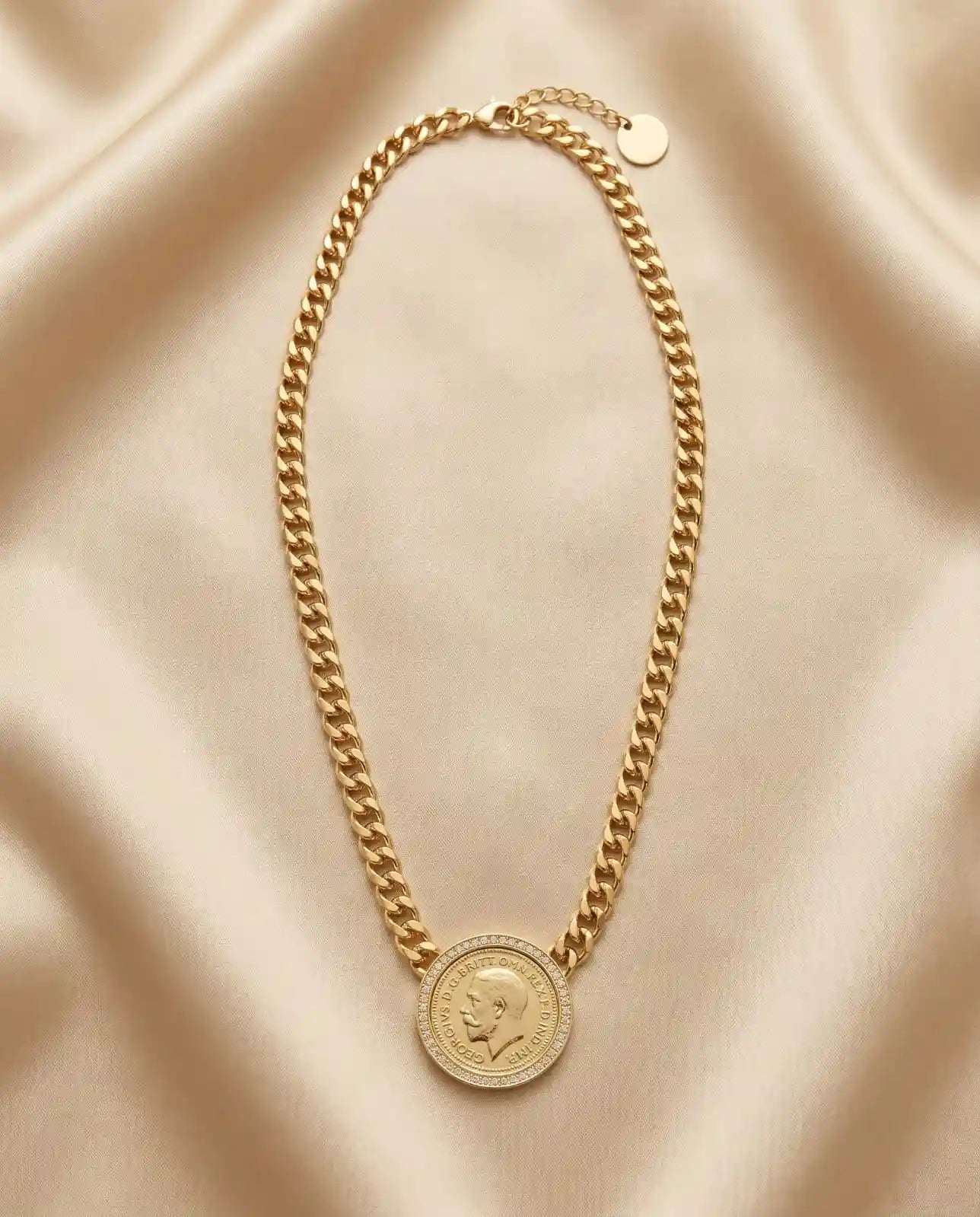 Gold plated statement necklace featuring a thick curb chain and a vintage engraved coin medallion framed with zircon crystals from Bellora Bloom.