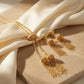 Gold-plated Tassel Pearl Heritage Jewelry Set on a beige fabric background