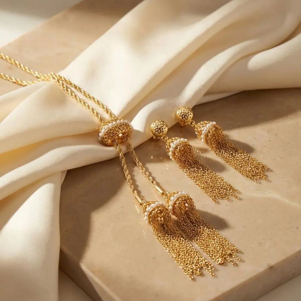 Gold-plated Tassel Pearl Heritage Jewelry Set on a beige fabric background