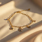 Gold-plated bracelet with star, moon, and eye pendants featuring blue and white crystals