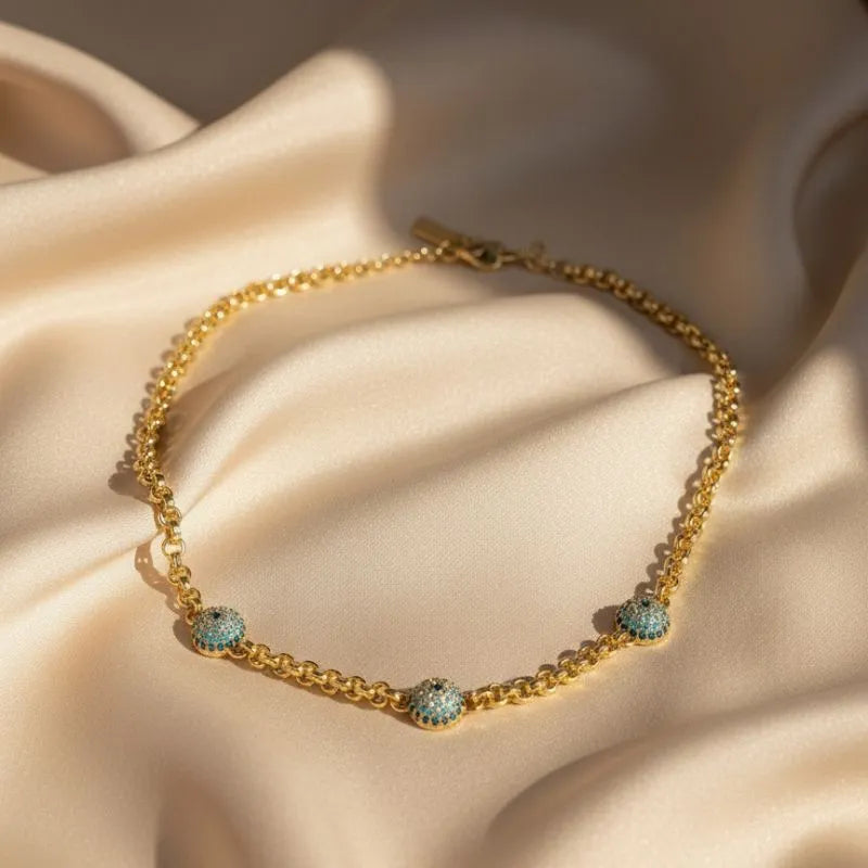 Gold-plated chain necklace with three turquoise evil eye charms