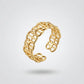 Gold chain-style ring on a light gray background
