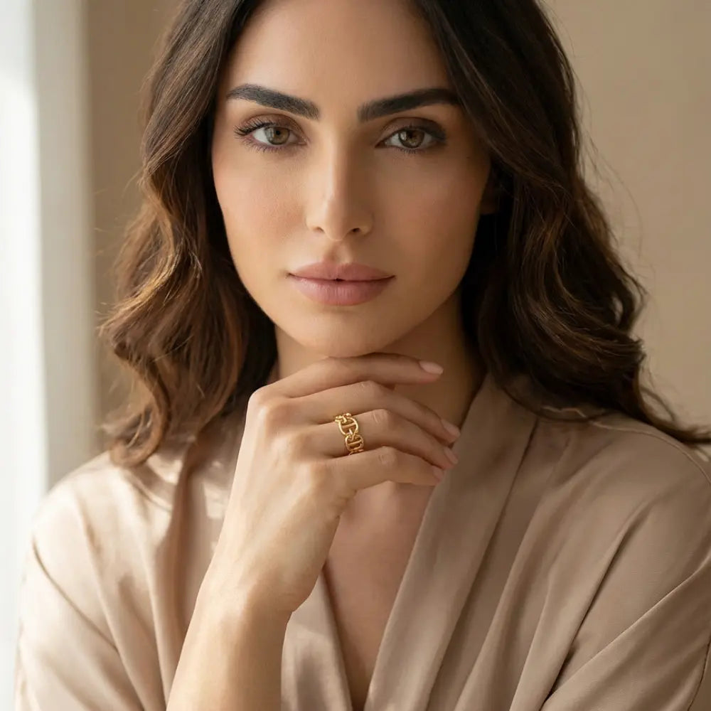 Woman wearing a gold ring with a neutral background