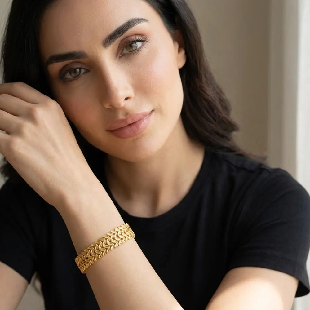 A woman wearing Gold Plated Double Row Leaf Link Bracelet