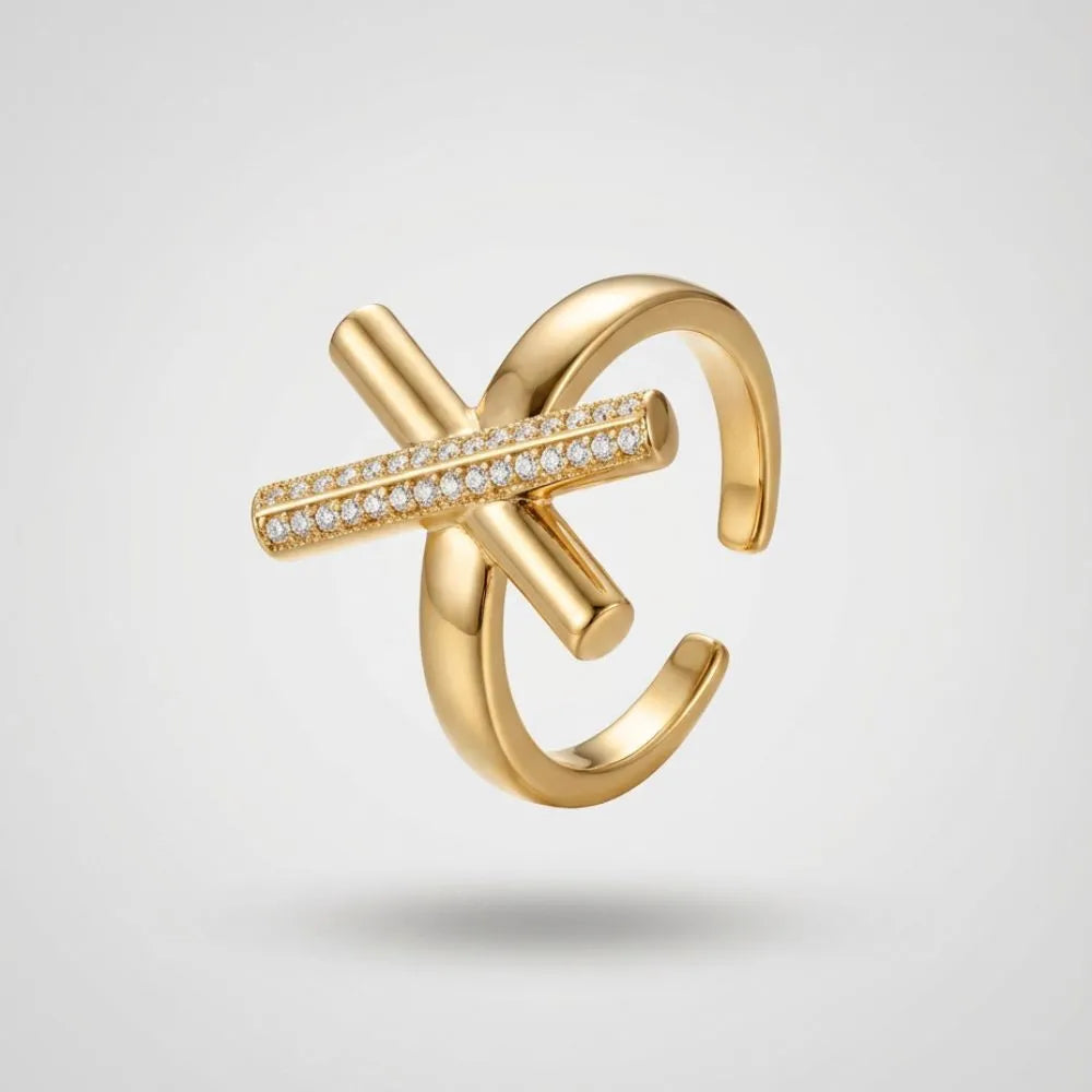 Gold ring with diamond accents on a light gray background