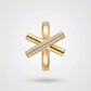 Gold cross-shaped pendant with embedded diamonds on a light gray background