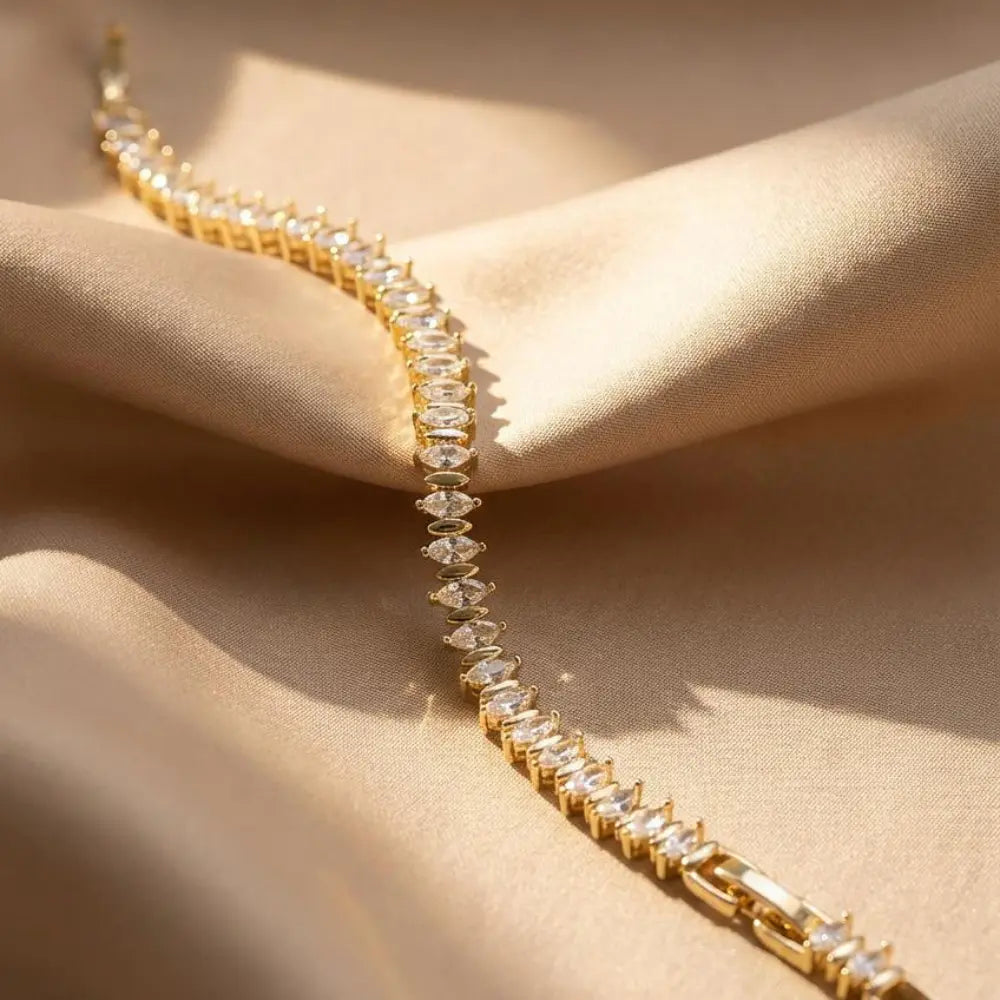 Gold Plated Marquise-Cut Tennis Bracelet on a beige fabric background