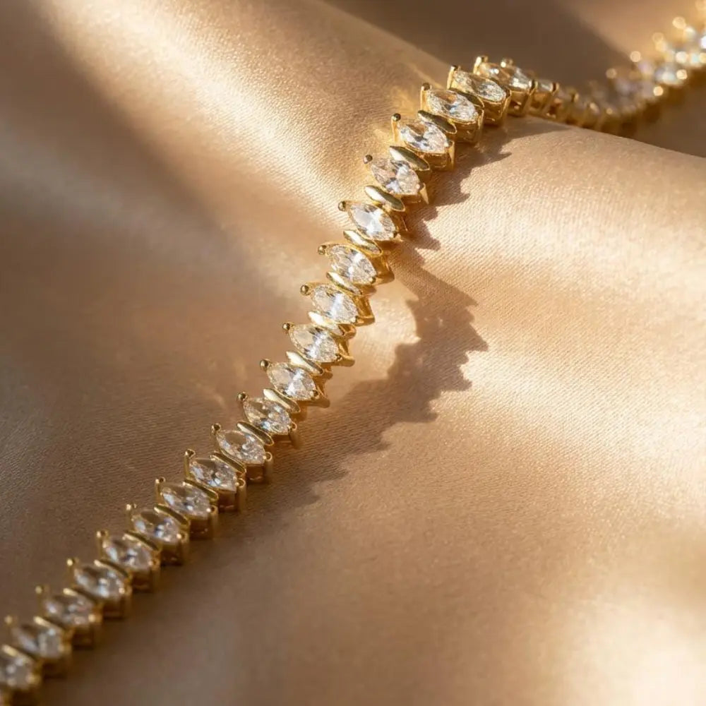 Gold Plated Marquise-Cut Tennis Bracelet on a beige fabric background  (1)