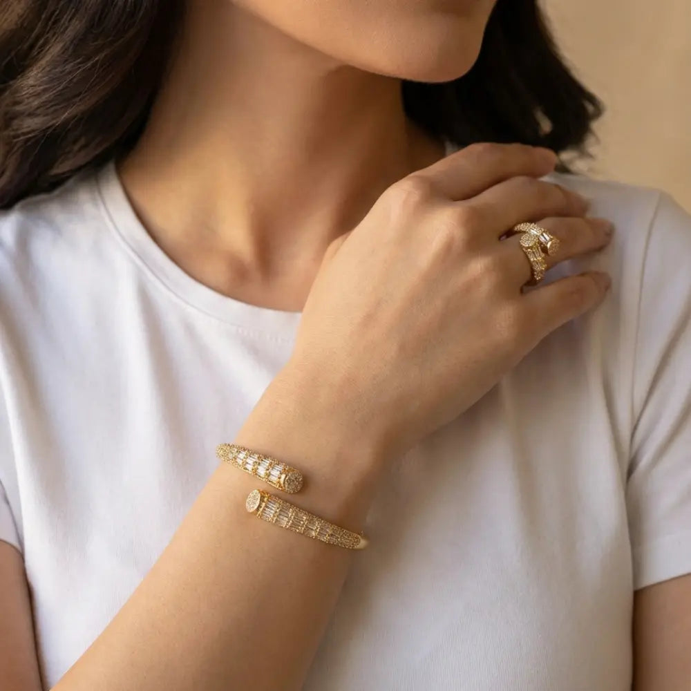 Close-up of a person wearing Gold Plated Crystal Baguette Cuff Bangle & Ring Set