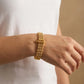  Gold Plated Ribbed Bead Bracelet on a wrist with a neutral background