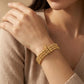  Gold Plated Ribbed Bead Bracelet on a person's wrist with a neutral background