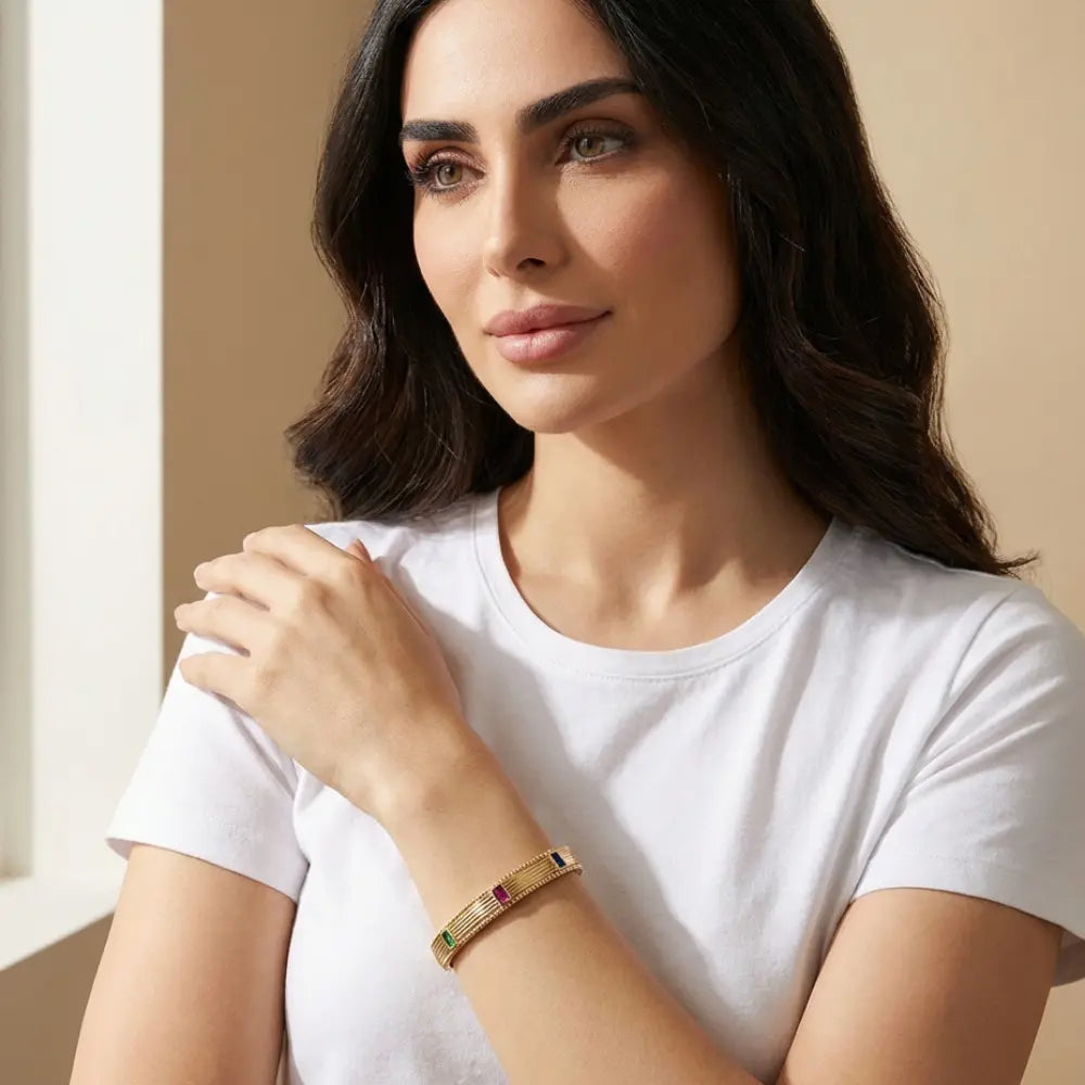 Woman wearing a Gold Plated hinged bangle Baguette Gemstone
