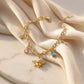 Elegant gold plated charm bracelet featuring a sparkling honey bee, vibrant colorful crystals, and delicate gold pendants from Bellora Bloom.