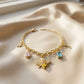 Elegant gold plated charm bracelet featuring a sparkling honey bee, vibrant colorful crystals, and delicate gold pendants from Bellora Bloom.