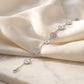 luxury silver alternating flower bracelet featuring sculpted white mother of pearl elements and brilliant cubic zirconia paved blossoms resting on elegant ivory satin.
