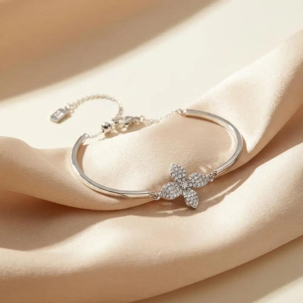 Silver Butterfly Adjustable Bracelet on a beige fabric background