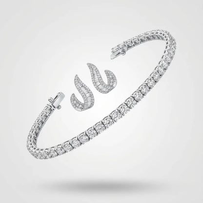 Silver tennis bracelet and curved stud earrings with baguette-cut diamonds on a neutral background.