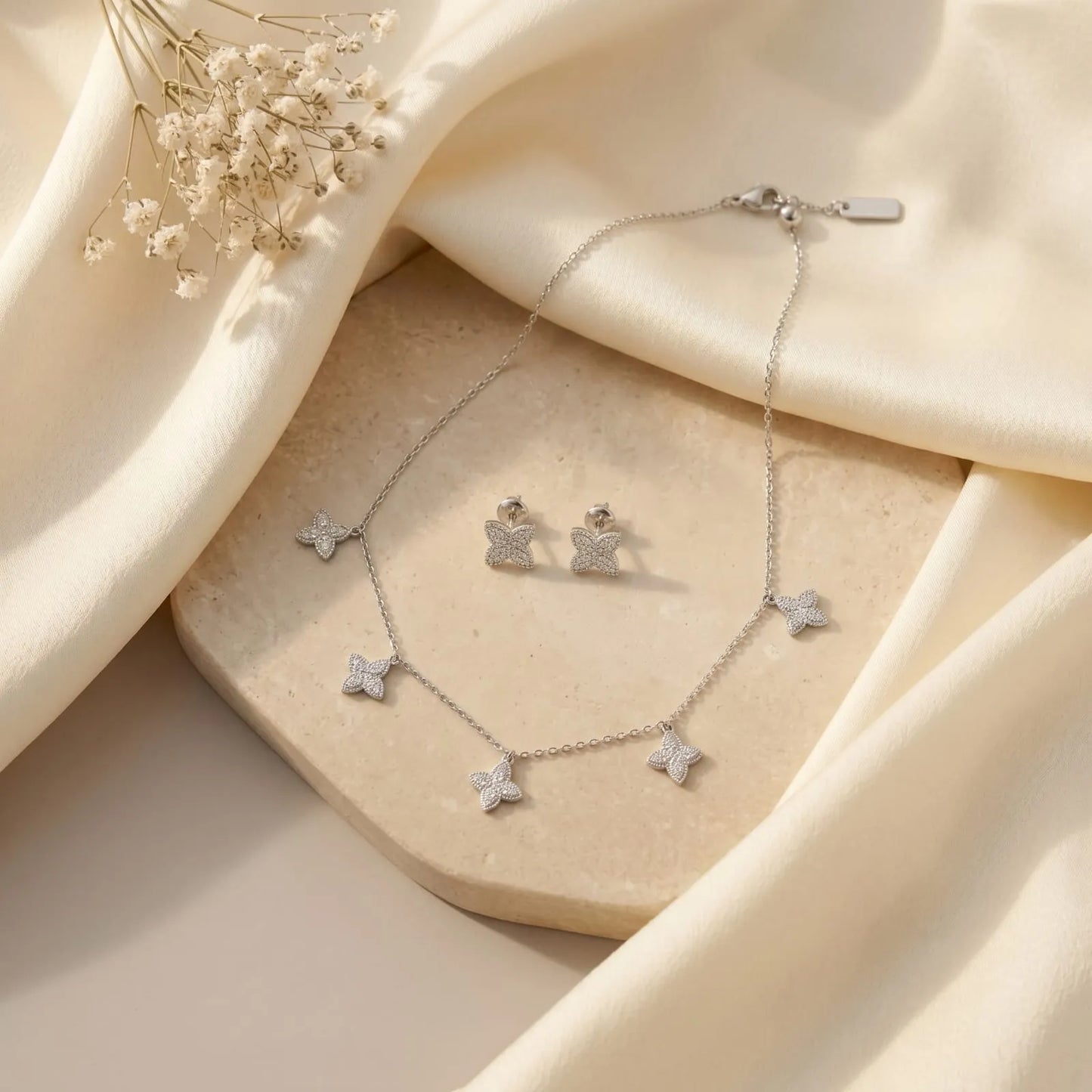 Elegant Silver Butterfly Necklace and matching Stud Earrings set adorned with shimmering stones.