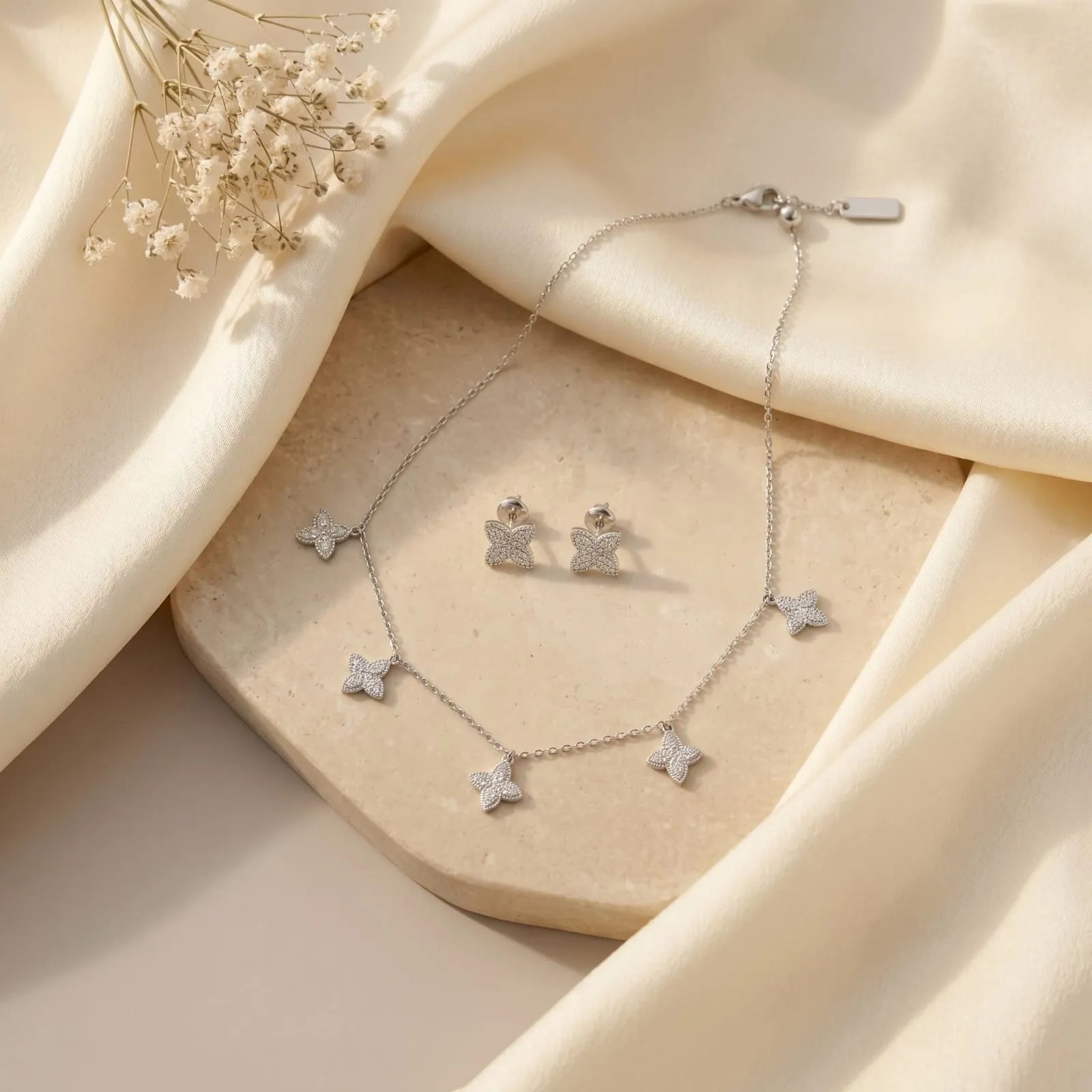 Elegant Silver Butterfly Necklace and matching Stud Earrings set adorned with shimmering stones.
