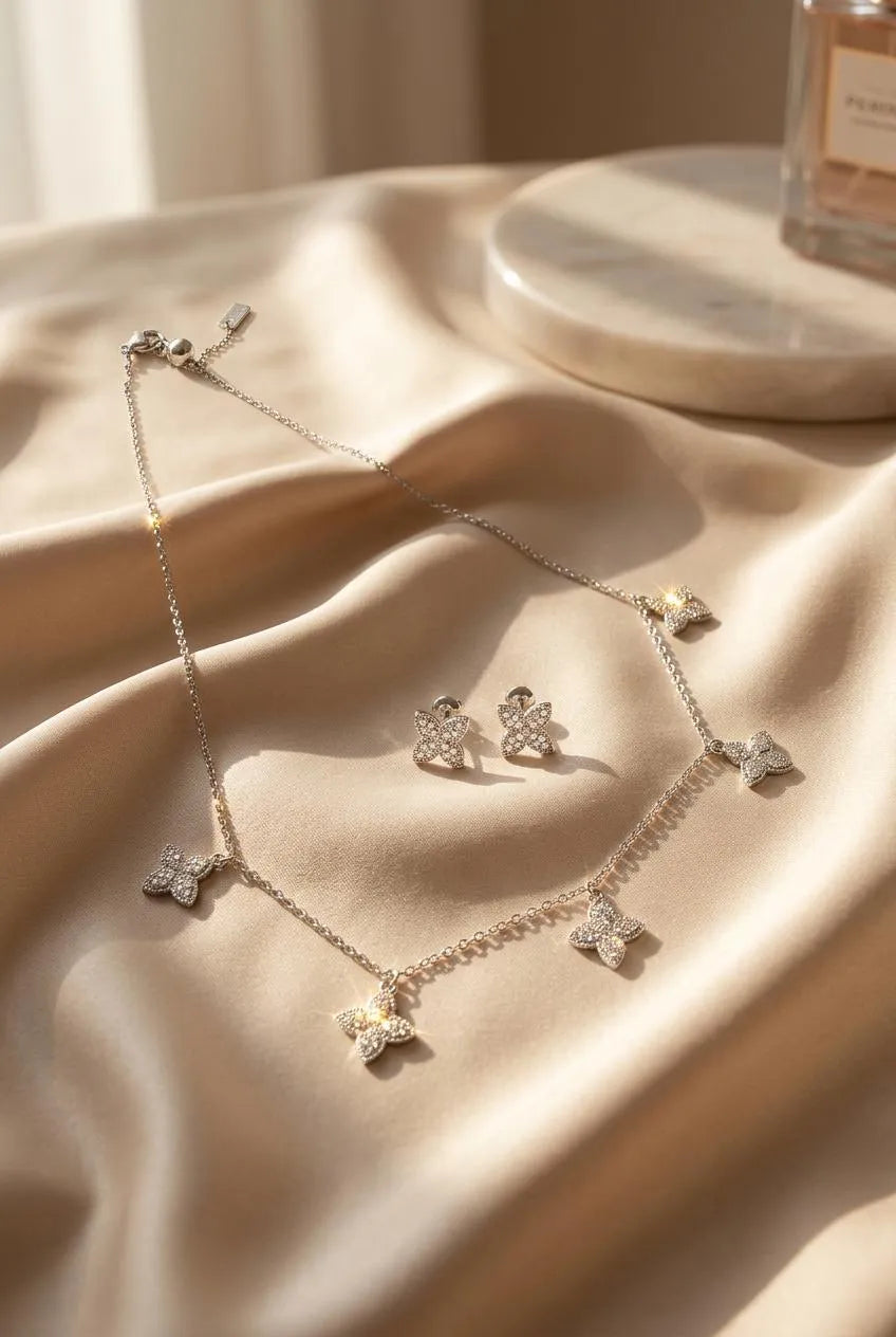 Elegant Silver Butterfly Necklace and matching Stud Earrings set adorned with shimmering stones.