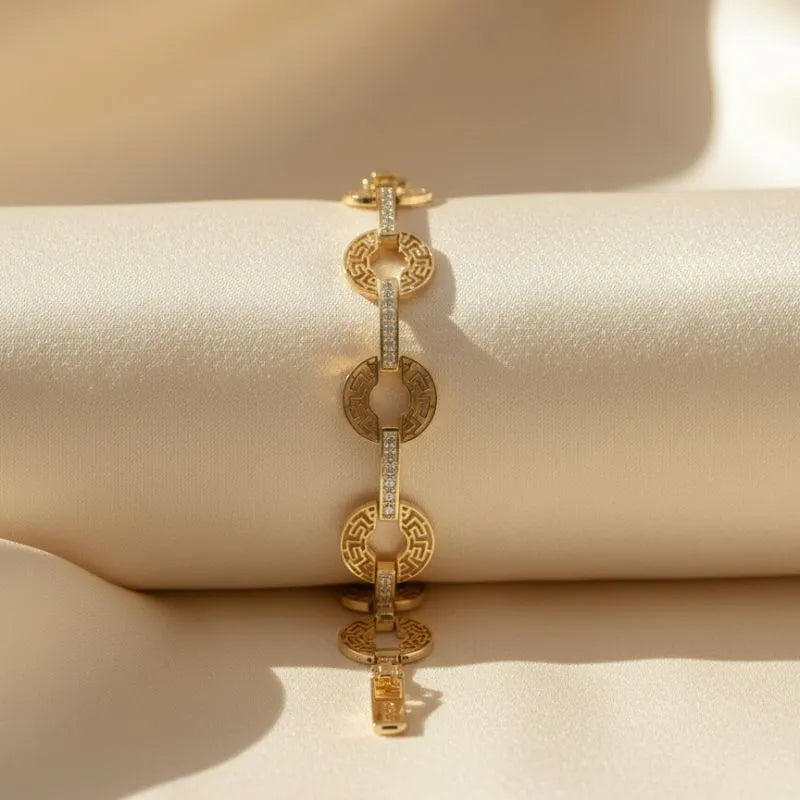 gold-toned bracelet with a Greek key pattern  and crystal accents