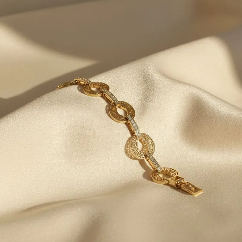 gold-toned bracelet with a Greek key pattern  and crystal accents